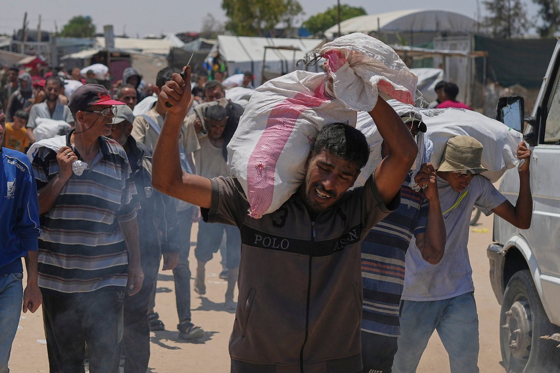 A Palestinian carries a bag containing food and humanitarian aid delivered by the Gaza Humanitarian Foundation, a U.S.-backed organization, in Rafah, southern Gaza Strip, Wednesday, June 11, 2025. (AP Photo/Abdel Kareem Hana) A Palestinian carries a bag containing food and humanitarian aid delivered by the Gaza Humanitarian Foundation, a U.S.-backed organization, in Rafah, southern Gaza Strip, Wednesday, June 11, 2025. (AP Photo/Abdel Kareem Hana)