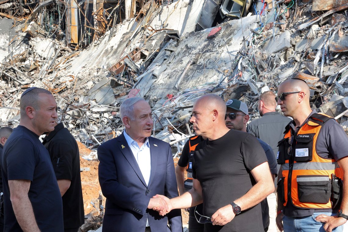 Israel's Prime Minister Benjamin Netanyahu shakes hands with Professor Alon Chen, President of the Weizmann Institute of Science, as he visits the facility's site which was hit by missiles fired from Iran, in the central city of Rehovot on Friday, June 20, 2025. (Jack Guez/Pool Photo via AP) Israel's Prime Minister Benjamin Netanyahu shakes hands with Professor Alon Chen, President of the Weizmann Institute of Science, as he visits the facility's site which was hit by missiles fired from Iran, in the central city of Rehovot on Friday, June 20, 2025. (Jack Guez/Pool Photo via AP)