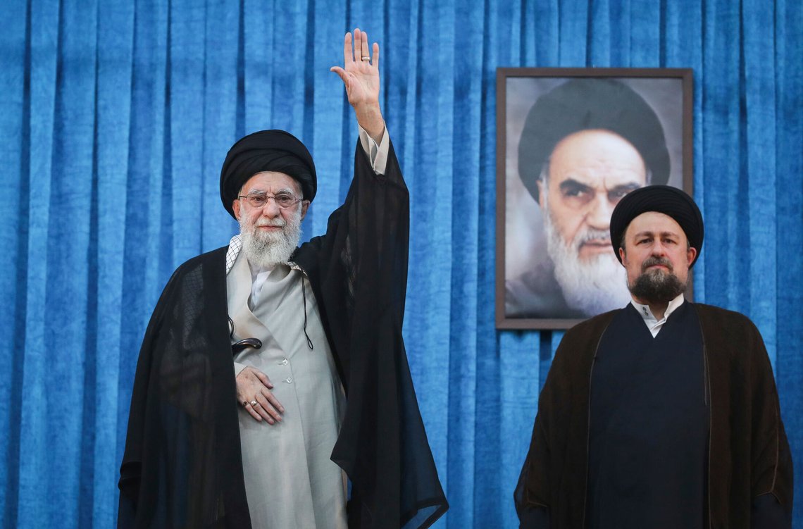 In this photo released by the official website of the office of the Iranian supreme leader, Supreme Leader Ayatollah Ali Khamenei waves to the crowd as he arrives for a ceremony marking the anniversary of the 1989 death of the late revolutionary founder Ayatollah Khomeini, shown in the poster in background, as Ayatollah Khomeini's grandson Hassan stands at right, at his shrine just outside Tehran, Iran, Wednesday, June 4, 2025. (Office of the Iranian Supreme Leader via AP) In this photo released by the official website of the office of the Iranian supreme leader, Supreme Leader Ayatollah Ali Khamenei waves to the crowd as he arrives for a ceremony marking the anniversary of the 1989 death of the late revolutionary founder Ayatollah Khomeini, shown in the poster in background, as Ayatollah Khomeini's grandson Hassan stands at right, at his shrine just outside Tehran, Iran, Wednesday, June 4, 2025. (Office of the Iranian Supreme Leader via AP)
