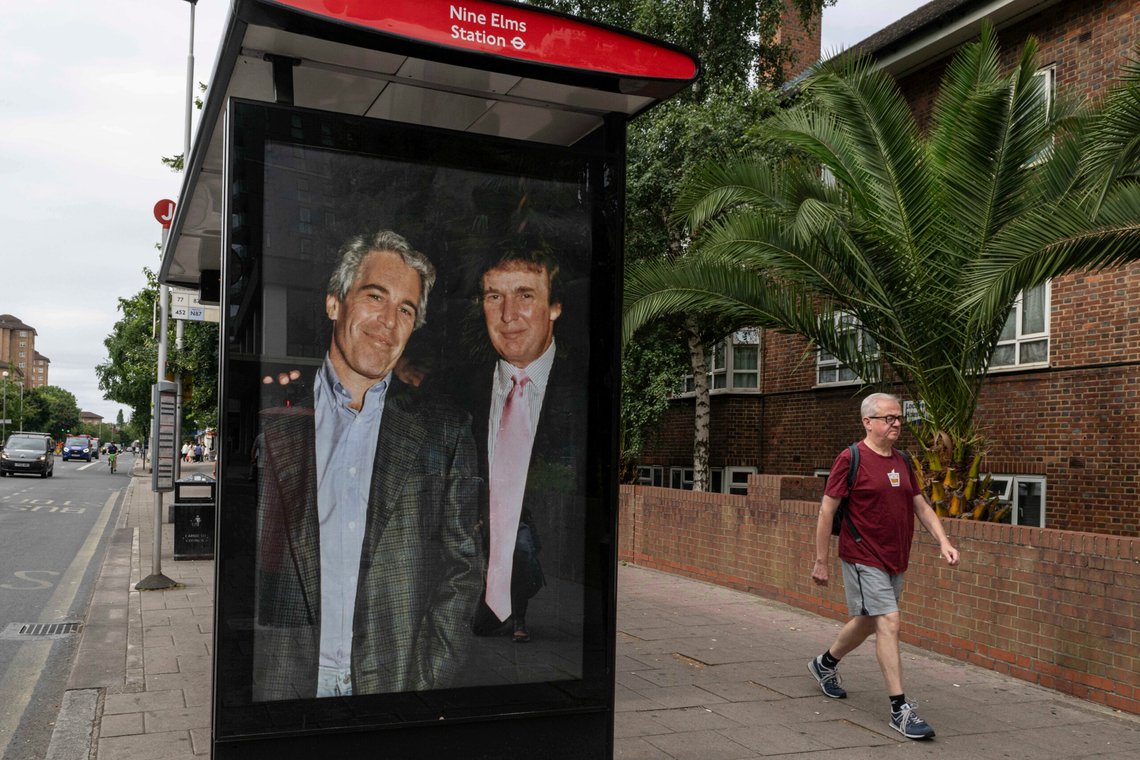 Commuters walk past a bus stop near Nine Elms Station as activists put up a poster showing President Donald Trump and Jeffrey Epstein near the US Embassy in London, Thursday, July 17, 2025.(AP Photo/Thomas Krych) Commuters walk past a bus stop near Nine Elms Station as activists put up a poster showing President Donald Trump and Jeffrey Epstein near the US Embassy in London, Thursday, July 17, 2025.(AP Photo/Thomas Krych)