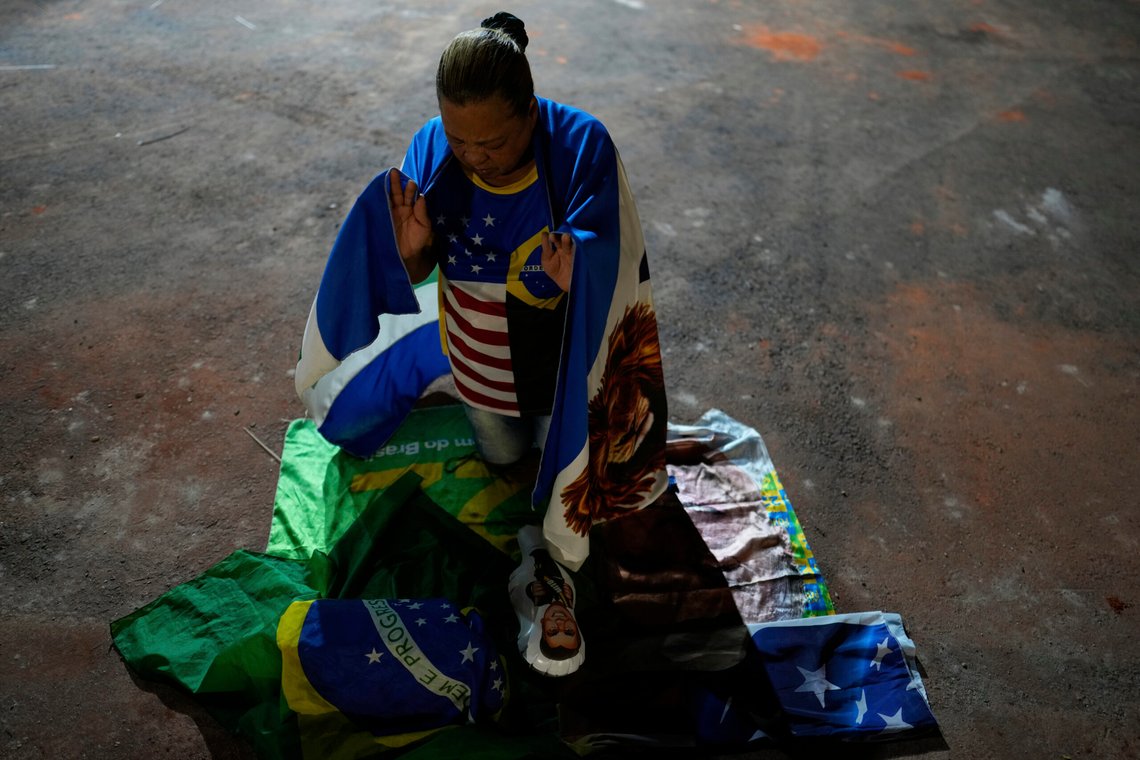 A supporter of Brazil's former President Jair Bolsonaro, prays during a vigil in his support near his home where he is under house arrest, in Brasilia, Brazil, Thursday, Sept. 11, 2025. (AP Photo/Eraldo Peres) A supporter of Brazil's former President Jair Bolsonaro, prays during a vigil in his support near his home where he is under house arrest, in Brasilia, Brazil, Thursday, Sept. 11, 2025. (AP Photo/Eraldo Peres)
