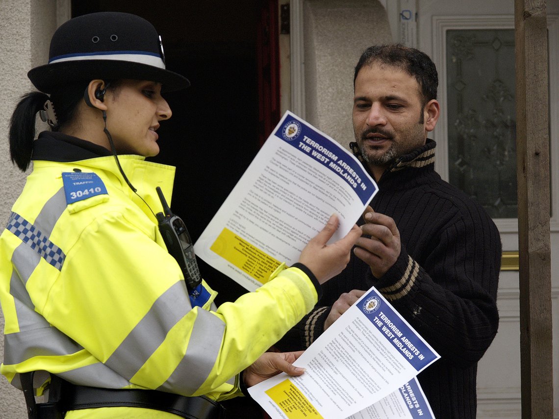 A local resident takes an explanatory leaflet from a police officer in Alum Rock road in Birmingham, England, Thursday Feb. 1, 2007. The leaflet explains in several languages why the police arrested 9 Muslims in anti terrorist raids in Birmingham Wednesday. (AP Photo/ Max Nash) A local resident takes an explanatory leaflet from a police officer in Alum Rock road in Birmingham, England, Thursday Feb. 1, 2007. The leaflet explains in several languages why the police arrested 9 Muslims in anti terrorist raids in Birmingham Wednesday. (AP Photo/ Max Nash)