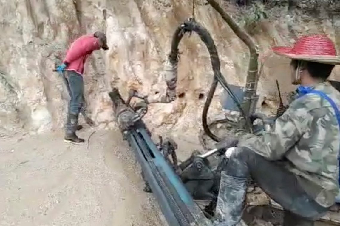 In this 2022 image from video provided by Global Witness, holes are drilled into the side of a mountain in the Kachin state of Myanmar, to mine rare earth minerals. Ammonium sulphate solution is injected into the holes, effectively liquefying the earth. Once the chemicals have percolated through the mountainside, the solution is drained into bright blue collection pools, where minerals are precipitated out. (Global Witness via AP) In this 2022 image from video provided by Global Witness, holes are drilled into the side of a mountain in the Kachin state of Myanmar, to mine rare earth minerals. Ammonium sulphate solution is injected into the holes, effectively liquefying the earth. Once the chemicals have percolated through the mountainside, the solution is drained into bright blue collection pools, where minerals are precipitated out. (Global Witness via AP)