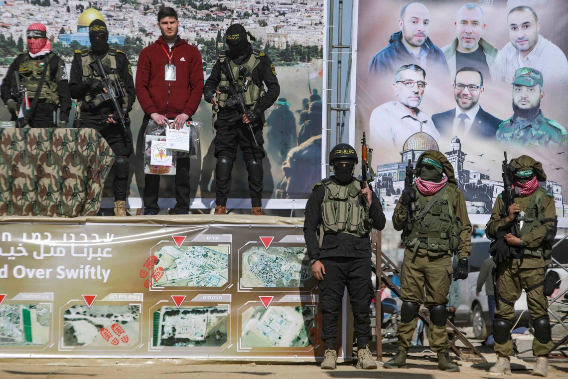 Israeli captive Alexander Troufanov, 29, third from left, who holds Israeli and Russian citizenship, is escorted by Hamas and Islamic Jihad fighters as he stands on a stage before being handed over to the Red Cross in Khan Younis, Gaza Strip, Saturday, Feb. 15, 2025. (AP Photo/Jehad Alshrafi) Israeli captive Alexander Troufanov, 29, third from left, who holds Israeli and Russian citizenship, is escorted by Hamas and Islamic Jihad fighters as he stands on a stage before being handed over to the Red Cross in Khan Younis, Gaza Strip, Saturday, Feb. 15, 2025. (AP Photo/Jehad Alshrafi)