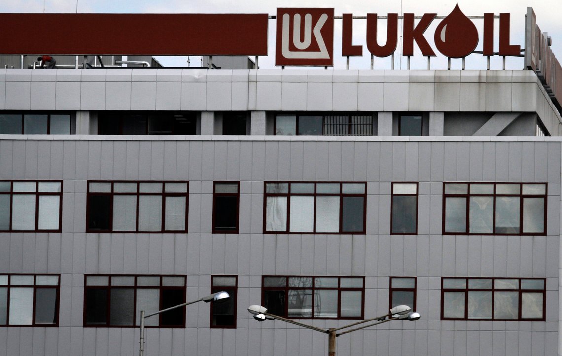 FILE - A worker, top left, works on the roof of the Lukoil headquarters in the Bulgarian capital Sofia, July 27, 2011. Bulgaria will allow Lukoil, a Black Sea refinery owned by a Russian oil company, to keep operating and exporting oil products to the European Union until the end of 2024 despite warnings by Brussels that it is against the bloc’s sanctions. (AP Photo/Valentina Petrova, File) FILE - A worker, top left, works on the roof of the Lukoil headquarters in the Bulgarian capital Sofia, July 27, 2011. Bulgaria will allow Lukoil, a Black Sea refinery owned by a Russian oil company, to keep operating and exporting oil products to the European Union until the end of 2024 despite warnings by Brussels that it is against the bloc’s sanctions. (AP Photo/Valentina Petrova, File)