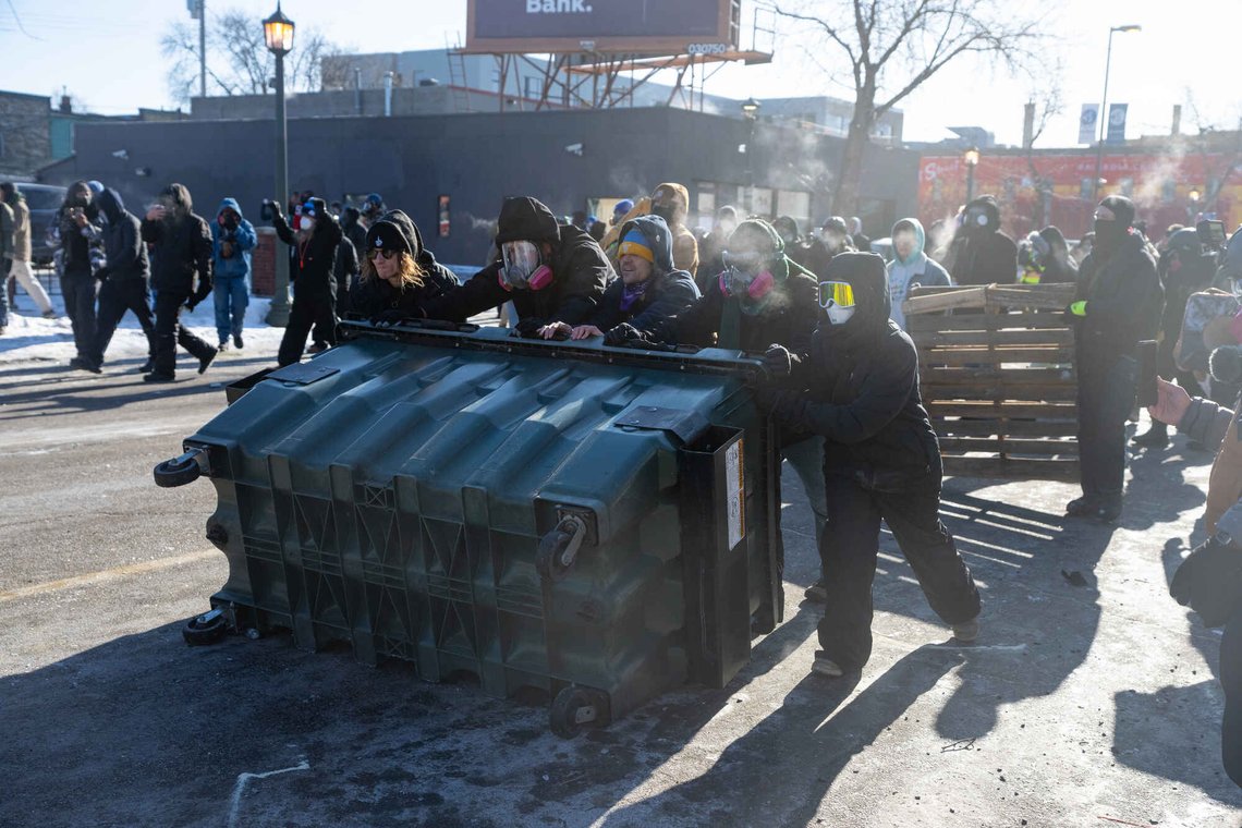 A group of protesters use a dumpster for cover on Nicollet Avenue as federal agents fire crowd control munitions at them after agents fatally shot Alex Pretti in Minneapolis, Minn., on Saturday, Jan. 24, 2026. (Aaron Nesheim/Sahan Journal/Catchlight Local via AP) A group of protesters use a dumpster for cover on Nicollet Avenue as federal agents fire crowd control munitions at them after agents fatally shot Alex Pretti in Minneapolis, Minn., on Saturday, Jan. 24, 2026. (Aaron Nesheim/Sahan Journal/Catchlight Local via AP)