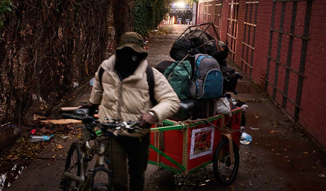 En migrant tar med seg eiendelene sine mens politiet forbereder seg på å gjennomføre utkastelsesordrer i en forlatt skolebygning, hvor hundrevis av hovedsakelig papirløse migranter hadde bodd, i Badalona i Spania den 17. desember 2025. Foto: Emilio Morenatti / AP / NTB. En migrant tar med seg eiendelene sine mens politiet forbereder seg på å gjennomføre utkastelsesordrer i en forlatt skolebygning, hvor hundrevis av hovedsakelig papirløse migranter hadde bodd, i Badalona i Spania den 17. desember 2025. Foto: Emilio Morenatti / AP / NTB.