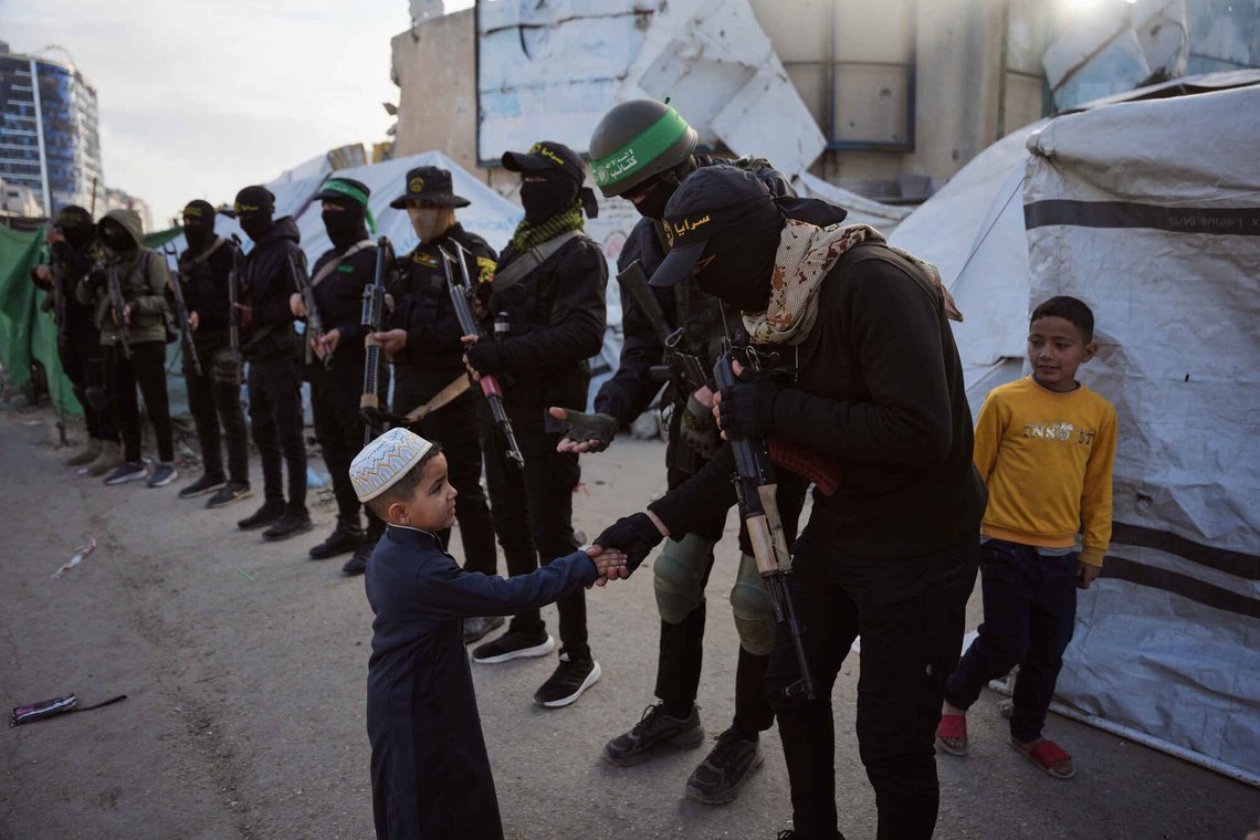 Terrorister fra Hamas og Islamsk Jihad hilser på folk som har samlet seg til Eid al-Fitr-bønnen i Gaza by, fredag 20. mars 2026. Indoktrineringen starter tidlig. Foto: AP /Abdel Kareem Hana/ NTB Terrorister fra Hamas og Islamsk Jihad hilser på folk som har samlet seg til Eid al-Fitr-bønnen i Gaza by, fredag 20. mars 2026. Indoktrineringen starter tidlig. Foto: AP /Abdel Kareem Hana/ NTB