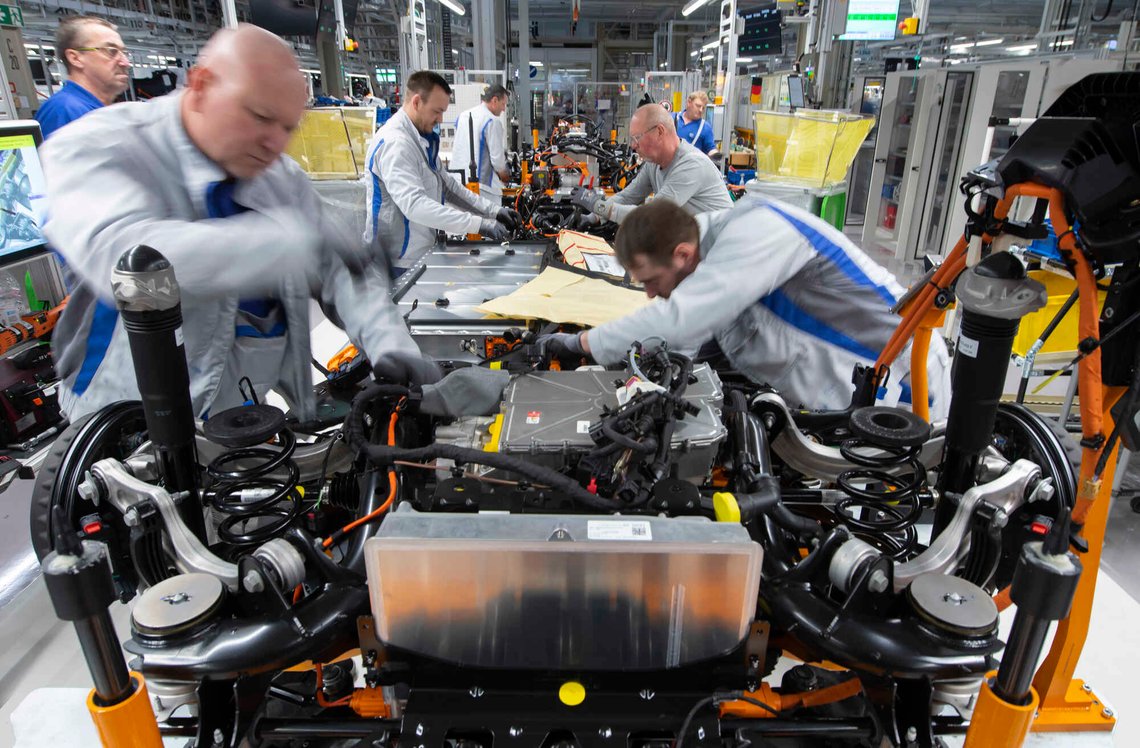 FILE - Workers complete an electric car ID.3 body at the assembly line during a press tour at the plant of the German manufacturer Volkswagen AG (VW) in Zwickau, Germany, Tuesday, Feb. 25. 2020. Germany's transport minister said Thursday that he opposes plans to ban the sale of new cars with combustion engines across the European Union in 2035, arguing this would discriminate against vehicles powered with synthetic fuels. EU lawmakers voted Wednesday to back the measure that requires automakers to cut carbon-dioxide emissions by 100% by the middle of the next decade, effectively prohibiting the sale in the 27-nation bloc of new cars powered by gasoline or diesel. (AP Photo/Jens Meyer, file) FILE - Workers complete an electric car ID.3 body at the assembly line during a press tour at the plant of the German manufacturer Volkswagen AG (VW) in Zwickau, Germany, Tuesday, Feb. 25. 2020. Germany's transport minister said Thursday that he opposes plans to ban the sale of new cars with combustion engines across the European Union in 2035, arguing this would discriminate against vehicles powered with synthetic fuels. EU lawmakers voted Wednesday to back the measure that requires automakers to cut carbon-dioxide emissions by 100% by the middle of the next decade, effectively prohibiting the sale in the 27-nation bloc of new cars powered by gasoline or diesel. (AP Photo/Jens Meyer, file)