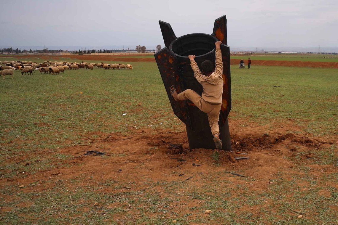 Exposing himself to the danger of unexploded ordnance, a boy tries to climb on an unexploded Iranian projectile that landed in an open field in the outskirts of Qamishli, eastern Syria, Wednesday, March 4, 2026. (AP Photo/Baderkhan Ahmad) Exposing himself to the danger of unexploded ordnance, a boy tries to climb on an unexploded Iranian projectile that landed in an open field in the outskirts of Qamishli, eastern Syria, Wednesday, March 4, 2026. (AP Photo/Baderkhan Ahmad)