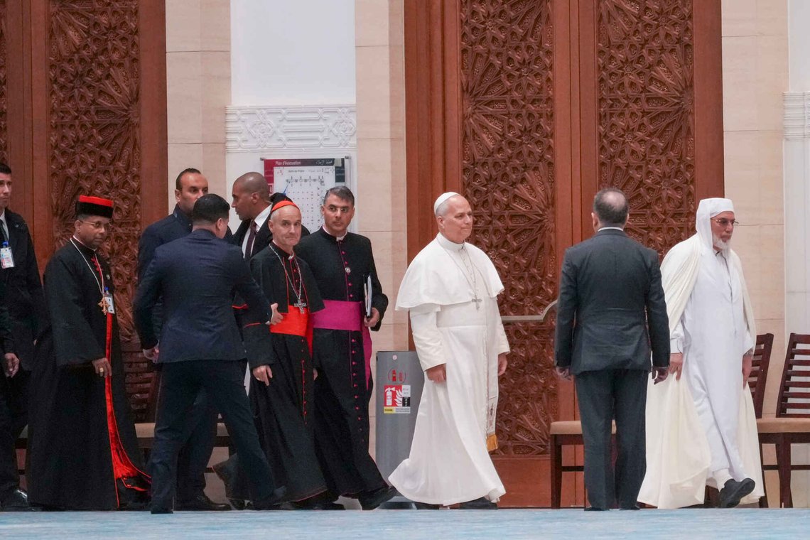 Pope Leo XIV is welcomed by Rector Mohamed Mamoun Al Qasimi, right, upon his arrival at the Great Mosque in Algiers with Cardinal Jean-Paul Vesco, Archbishop of Algiers, fifth from right, and Cardinal George Jacob Koovakad, Prefect of the Dicastery for Interreligious Dialogue, ninth from right, Monday, April 13, 2026, on the first day of an 11-day apostolic journey to Africa. (AP Photo/Andrew Medichini) Pope Leo XIV is welcomed by Rector Mohamed Mamoun Al Qasimi, right, upon his arrival at the Great Mosque in Algiers with Cardinal Jean-Paul Vesco, Archbishop of Algiers, fifth from right, and Cardinal George Jacob Koovakad, Prefect of the Dicastery for Interreligious Dialogue, ninth from right, Monday, April 13, 2026, on the first day of an 11-day apostolic journey to Africa. (AP Photo/Andrew Medichini)