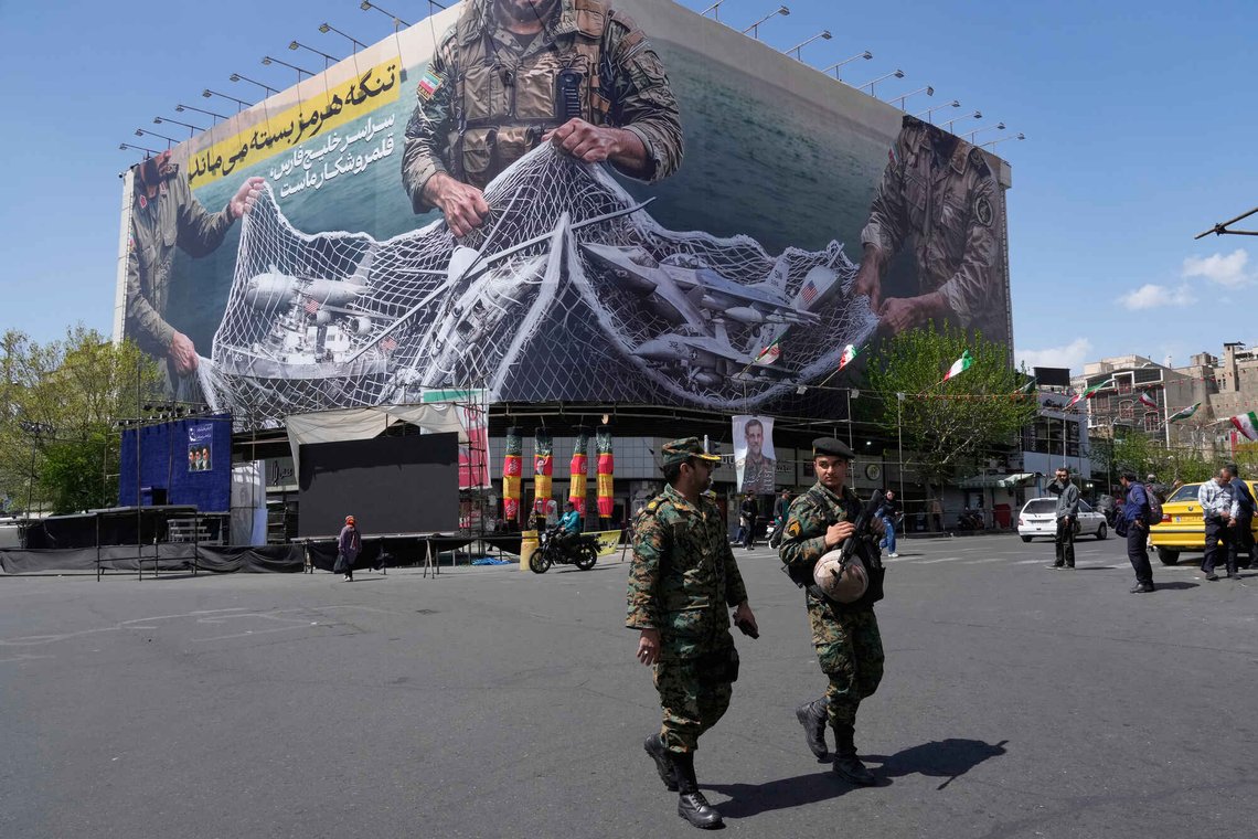 Two police officers walk in front of an anti-U.S. billboard depicting the American aircrafts into the Iranian armed forces fishing net with signs that read in Farsi: "The Strait of Hormuz will remain closed, The entire Persian Gulf is our hunting ground," at the Eqelab-e-Eslami, or Islamic Revolution square in downtown Tehran, Iran, Sunday, April 5, 2026. (AP Photo/Vahid Salemi) Two police officers walk in front of an anti-U.S. billboard depicting the American aircrafts into the Iranian armed forces fishing net with signs that read in Farsi: "The Strait of Hormuz will remain closed, The entire Persian Gulf is our hunting ground," at the Eqelab-e-Eslami, or Islamic Revolution square in downtown Tehran, Iran, Sunday, April 5, 2026. (AP Photo/Vahid Salemi)