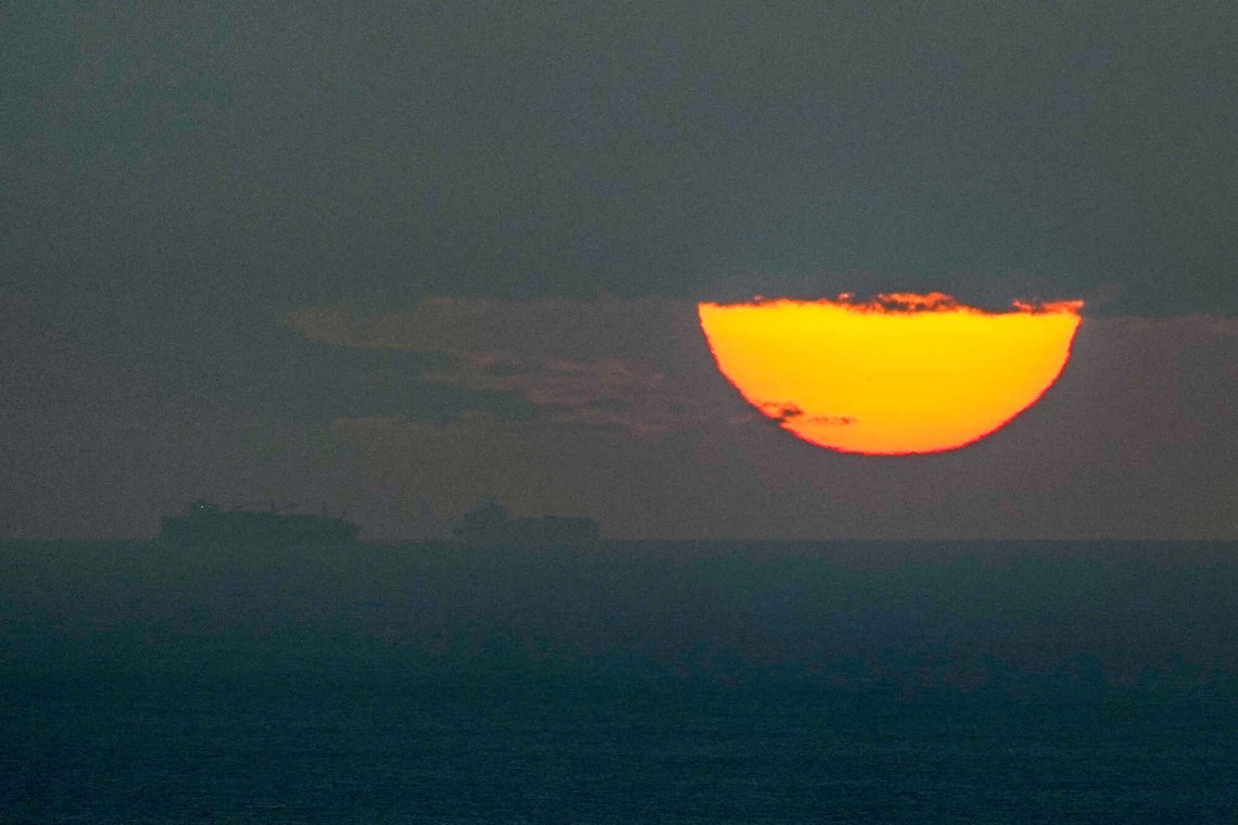 FILE - Ships sail through the Arabian Gulf toward the Strait of Hormuz as the sun sets in the United Arab Emirates Monday, March 23, 2026. (AP Photo, File) FILE - Ships sail through the Arabian Gulf toward the Strait of Hormuz as the sun sets in the United Arab Emirates Monday, March 23, 2026. (AP Photo, File)
