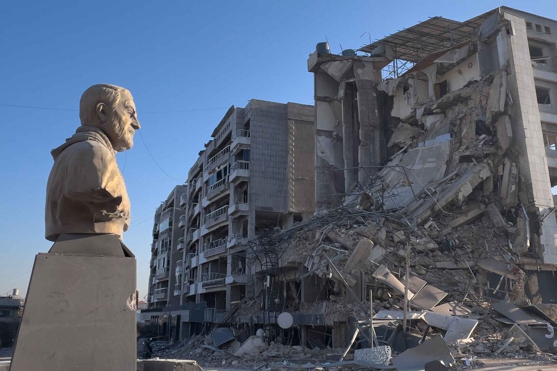 A bust of the late Iranian General Qassem Soleimani stands in front of a destroyed building that housed a branch of Al-Qard Al-Hassan, a non-bank financial institution run by Hezbollah, which was hit by an Israeli airstrike in Dahiyeh, Beirut's southern suburbs, Lebanon, Tuesday, March 10, 2026. (AP Photo/Hussein Malla) A bust of the late Iranian General Qassem Soleimani stands in front of a destroyed building that housed a branch of Al-Qard Al-Hassan, a non-bank financial institution run by Hezbollah, which was hit by an Israeli airstrike in Dahiyeh, Beirut's southern suburbs, Lebanon, Tuesday, March 10, 2026. (AP Photo/Hussein Malla)