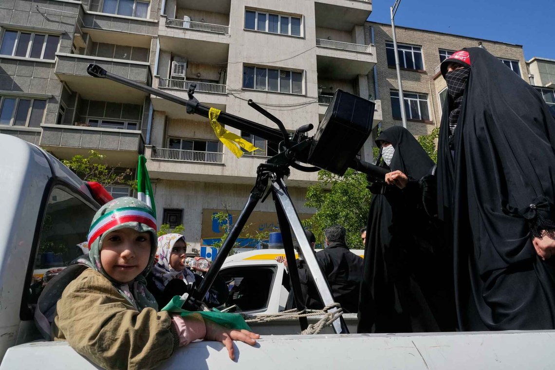 Women members of the Basij paramilitary, affiliated with Iran's Revolutionary Guard, ride on a pickup truck mounted with a machine gun during a state-organized rally in support of the supreme leader marking National Girl's Day in Tehran, Iran, Friday, April 17, 2026. (AP Photo/Vahid Salemi) Women members of the Basij paramilitary, affiliated with Iran's Revolutionary Guard, ride on a pickup truck mounted with a machine gun during a state-organized rally in support of the supreme leader marking National Girl's Day in Tehran, Iran, Friday, April 17, 2026. (AP Photo/Vahid Salemi)