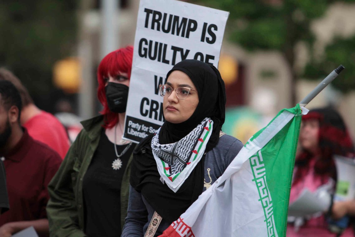 Zainab Haider holds a flag during a protest against the Iran war on Wednesday, April 8, 2026, in Austin, Texas. (Brianna Griffith via AP) Zainab Haider holds a flag during a protest against the Iran war on Wednesday, April 8, 2026, in Austin, Texas. (Brianna Griffith via AP)