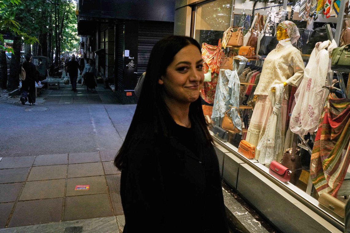 A woman smiles at the camera outside a women's clothing shop in northern Tehran, Iran, Sunday, May 10, 2026. (AP Photo/Vahid Salemi) A woman smiles at the camera outside a women's clothing shop in northern Tehran, Iran, Sunday, May 10, 2026. (AP Photo/Vahid Salemi)