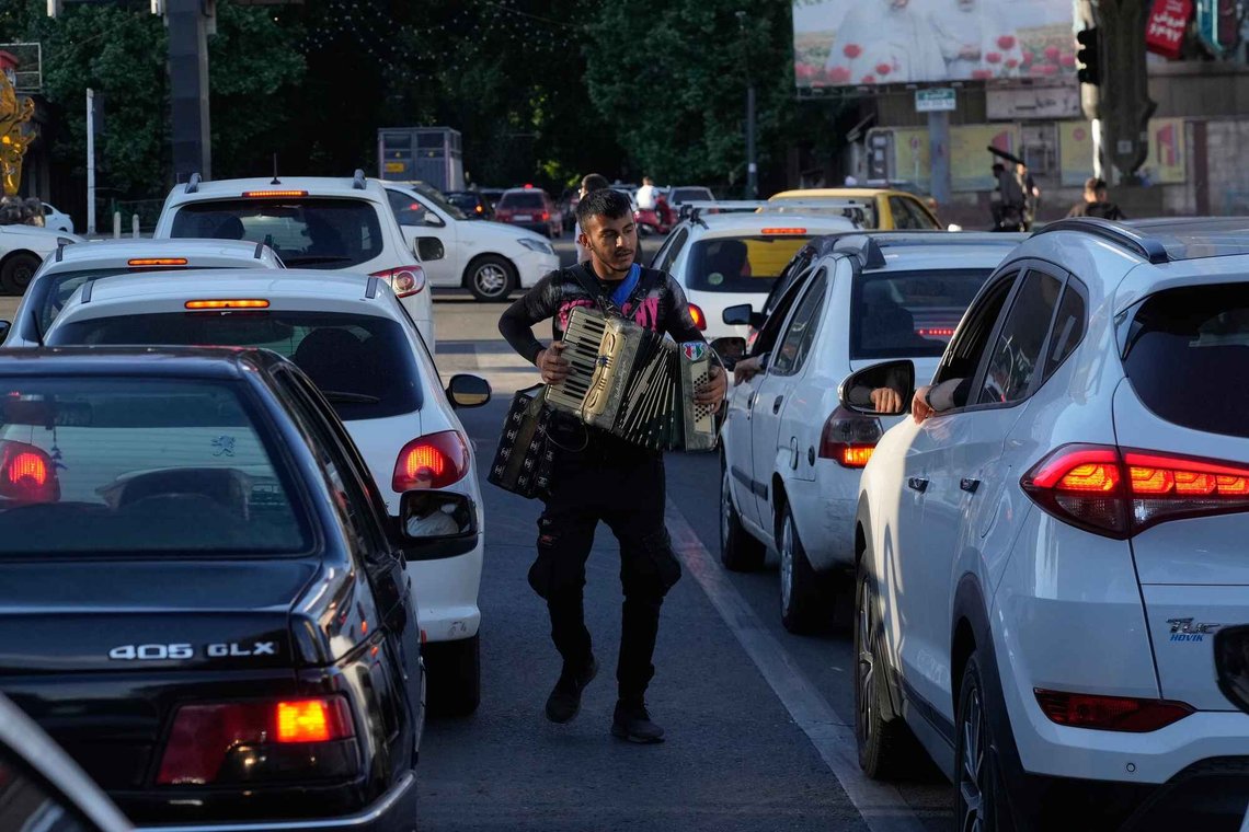 A street musician plays an accordion between cars in traffic in northern Tehran, Iran, Tuesday, May 26, 2026. (AP Photo/Vahid Salemi) A street musician plays an accordion between cars in traffic in northern Tehran, Iran, Tuesday, May 26, 2026. (AP Photo/Vahid Salemi)