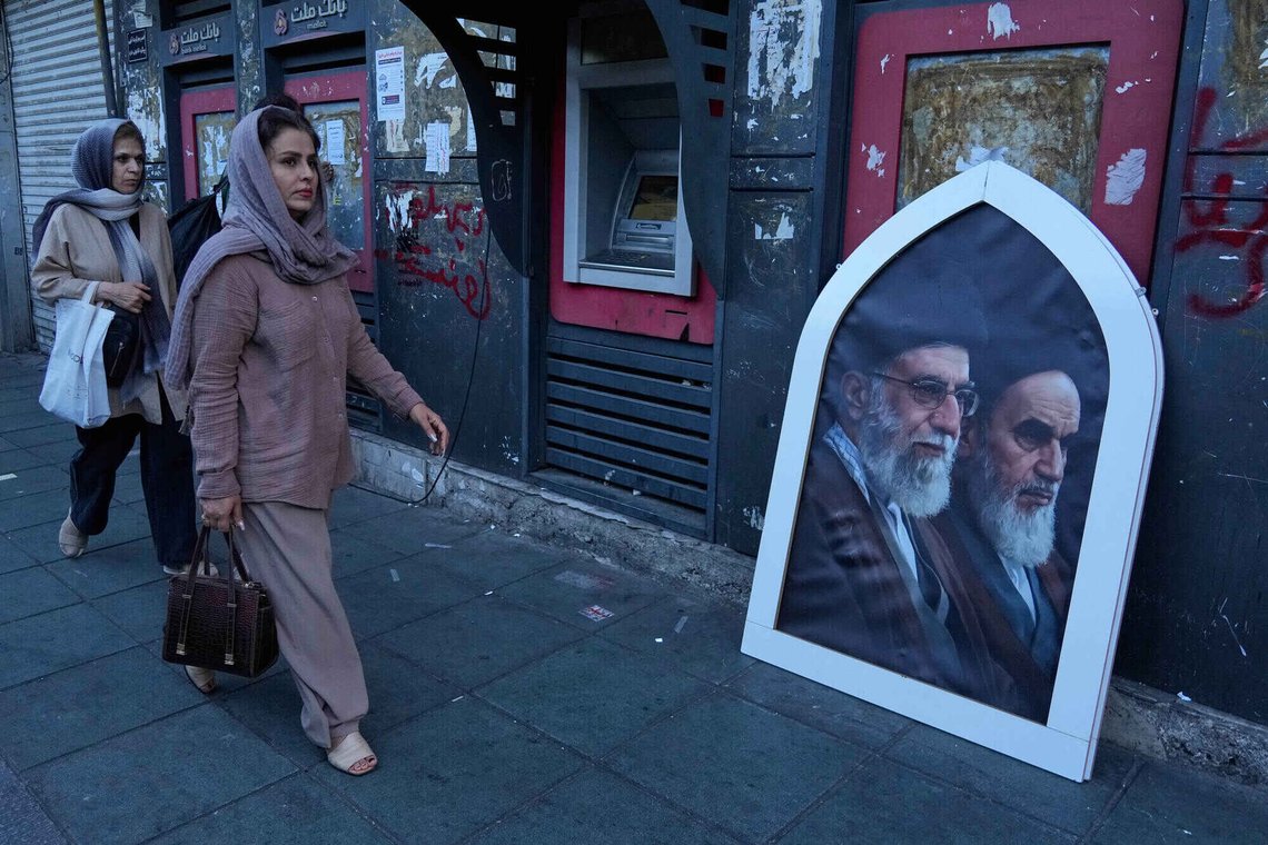 Pedestrians walk past a poster showing the slain Iranian Supreme Leader Ayatollah Ali Khamenei, left, and the late revolutionary founder Ayatollah Khomeini on a sidewalk at the Islamic Revolution square in Tehran, Iran, Sunday, June 14, 2026. (AP Photo/Vahid Salemi) Pedestrians walk past a poster showing the slain Iranian Supreme Leader Ayatollah Ali Khamenei, left, and the late revolutionary founder Ayatollah Khomeini on a sidewalk at the Islamic Revolution square in Tehran, Iran, Sunday, June 14, 2026. (AP Photo/Vahid Salemi)