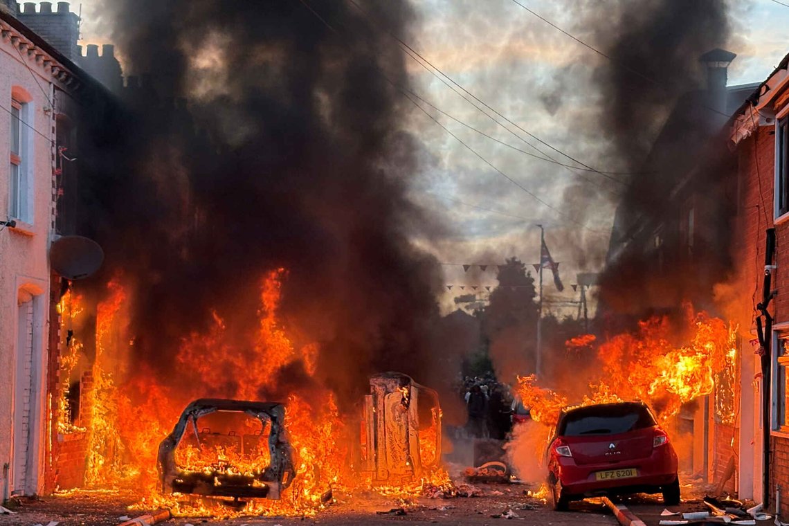Vehicles set on fire by protesters burn on Lendrick Street in east Belfast, Northern Ireland, on Tuesday, June 9, 2026, after the arrest of a Sudanese man accused of stabbing a man in the northern part of the city. (PA via AP) Vehicles set on fire by protesters burn on Lendrick Street in east Belfast, Northern Ireland, on Tuesday, June 9, 2026, after the arrest of a Sudanese man accused of stabbing a man in the northern part of the city. (PA via AP)