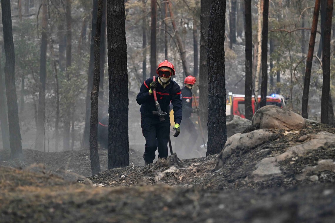 A firefighter carries a fire hose after a wildfire in the region of the Fontainebleau forest, south of Paris, France, Tuesday, July 14, 2026. (AP Photo/Emma Da Silva) A firefighter carries a fire hose after a wildfire in the region of the Fontainebleau forest, south of Paris, France, Tuesday, July 14, 2026. (AP Photo/Emma Da Silva)