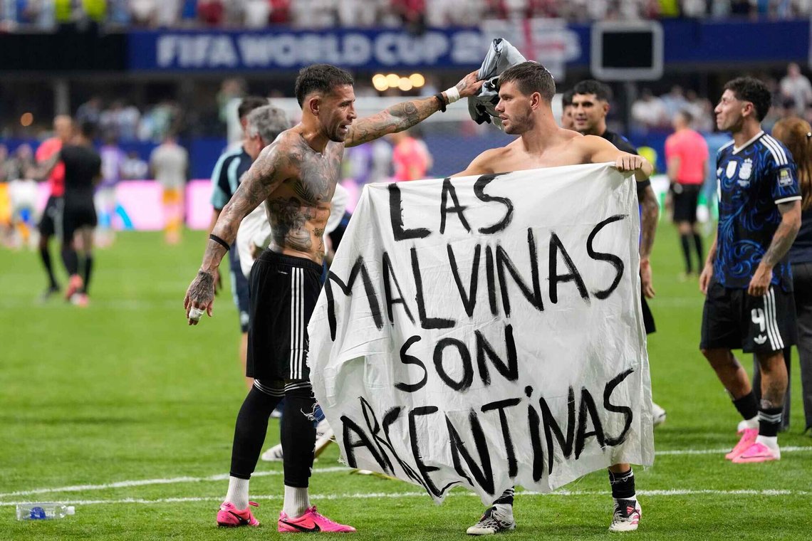 Argentina's Giovani Lo Celso holds a banner with the words "The Malvinas are Argentine", referring to the Falkland Islands, while teammate Argentina's Nicolas Otamendi gestures to him, at the end of the World Cup semifinal soccer match between England and Argentina in Atlanta, Wednesday, July 15, 2026. (AP Photo/Rebecca Blackwell) Argentina's Giovani Lo Celso holds a banner with the words "The Malvinas are Argentine", referring to the Falkland Islands, while teammate Argentina's Nicolas Otamendi gestures to him, at the end of the World Cup semifinal soccer match between England and Argentina in Atlanta, Wednesday, July 15, 2026. (AP Photo/Rebecca Blackwell)