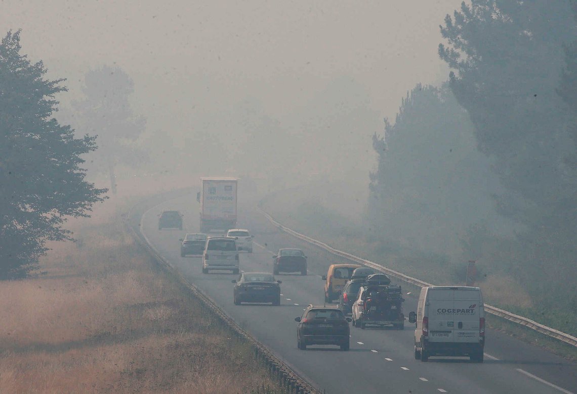 Trucks and cars drive on the A63 motorway invaded by smoke caused by the forest fire fifty km south of Bordeaux, near Belin-Béliet, southwestern France, Monday, July 18, 2022. France scrambled more water-bombing planes and hundreds more firefighters to combat spreading wildfires that were being fed Monday by hot swirling winds from a searing heat wave broiling much of Europe. With winds changing direction, authorities in southwestern France announced plans to evacuate more towns and move out 3,500 people at risk of finding themselves in the path of the raging flames. (AP Photo/Bob Edme) Trucks and cars drive on the A63 motorway invaded by smoke caused by the forest fire fifty km south of Bordeaux, near Belin-Béliet, southwestern France, Monday, July 18, 2022. France scrambled more water-bombing planes and hundreds more firefighters to combat spreading wildfires that were being fed Monday by hot swirling winds from a searing heat wave broiling much of Europe. With winds changing direction, authorities in southwestern France announced plans to evacuate more towns and move out 3,500 people at risk of finding themselves in the path of the raging flames. (AP Photo/Bob Edme)