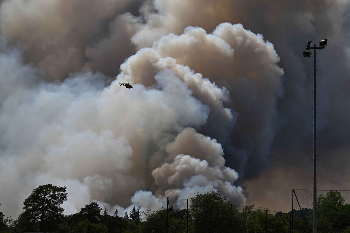 A fire fighting helicopter in action as wildfires are seen in the Fontainebleau forest region, about 60 kilometers (37 miles) south of Paris, France, Monday, July 13, 2026. (AP Photo/Emma Da Silva) A fire fighting helicopter in action as wildfires are seen in the Fontainebleau forest region, about 60 kilometers (37 miles) south of Paris, France, Monday, July 13, 2026. (AP Photo/Emma Da Silva)