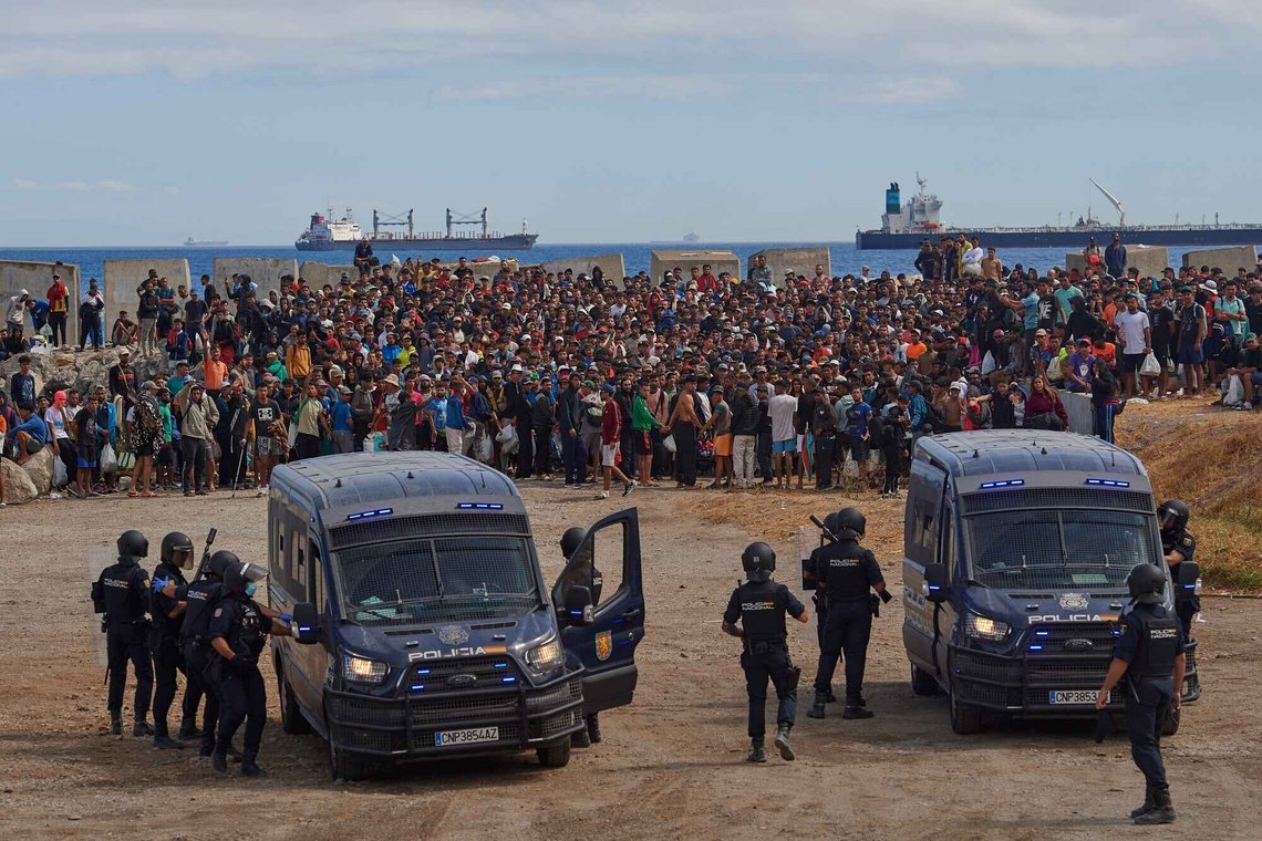 Migrants who crossed from Morocco into Spain return to a beach after being expelled from the area the previous day, as Spanish police escort them in the Spanish exclave of Ceuta, Friday, Aug. 21, 2026. (AP Photo/Antonio Sempere) Migrants who crossed from Morocco into Spain return to a beach after being expelled from the area the previous day, as Spanish police escort them in the Spanish exclave of Ceuta, Friday, Aug. 21, 2026. (AP Photo/Antonio Sempere)