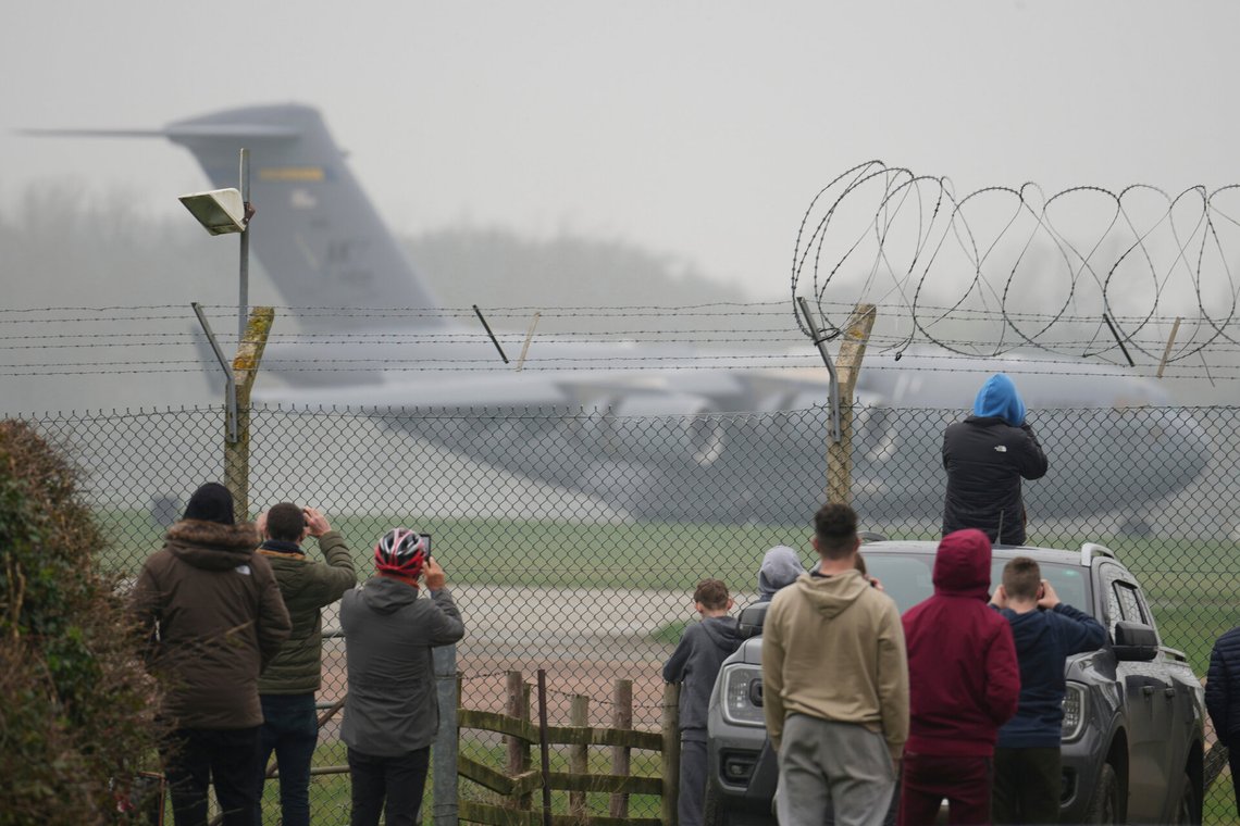 People watch as a U.S. C17 cargo plane come into land behind two U.S .B1 Lancer bombers parked on the apron at RAF Fairford, England, Sunday, March 8, 2026. (AP Photo/Alastair Grant) People watch as a U.S. C17 cargo plane come into land behind two U.S .B1 Lancer bombers parked on the apron at RAF Fairford, England, Sunday, March 8, 2026. (AP Photo/Alastair Grant)