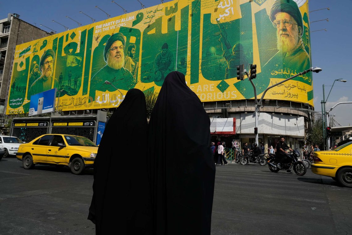 Women stands in an intersection in front of a billboard showing portraits of the late Iranian Supreme Leader Ayatollah Ali Khamenei, right, late leaders of Lebanon's Hezbollah group Hassan Nasrallah, center left, and Hashem Safieddine, left, marking the second anniversary of the killing of Hassan Nasrallah, in Tehran, Iran, Sunday, Sept. 27, 2026. (AP Photo/Vahid Salemi) Women stands in an intersection in front of a billboard showing portraits of the late Iranian Supreme Leader Ayatollah Ali Khamenei, right, late leaders of Lebanon's Hezbollah group Hassan Nasrallah, center left, and Hashem Safieddine, left, marking the second anniversary of the killing of Hassan Nasrallah, in Tehran, Iran, Sunday, Sept. 27, 2026. (AP Photo/Vahid Salemi)