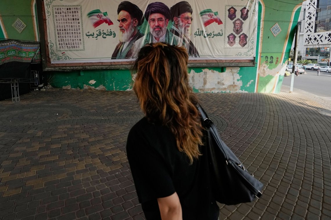A woman walks past a banner showing portraits of the late Iranian revolutionary founder Ayatollah Khomeini, left, Supreme Leader Ayatollah Mojtaba Khamenei, center, and the late Supreme Leader Ayatollah Ali Khamenei in northern Tehran, Iran, Saturday, Sept. 12, 2026. (AP Photo/Vahid Salemi) A woman walks past a banner showing portraits of the late Iranian revolutionary founder Ayatollah Khomeini, left, Supreme Leader Ayatollah Mojtaba Khamenei, center, and the late Supreme Leader Ayatollah Ali Khamenei in northern Tehran, Iran, Saturday, Sept. 12, 2026. (AP Photo/Vahid Salemi)
