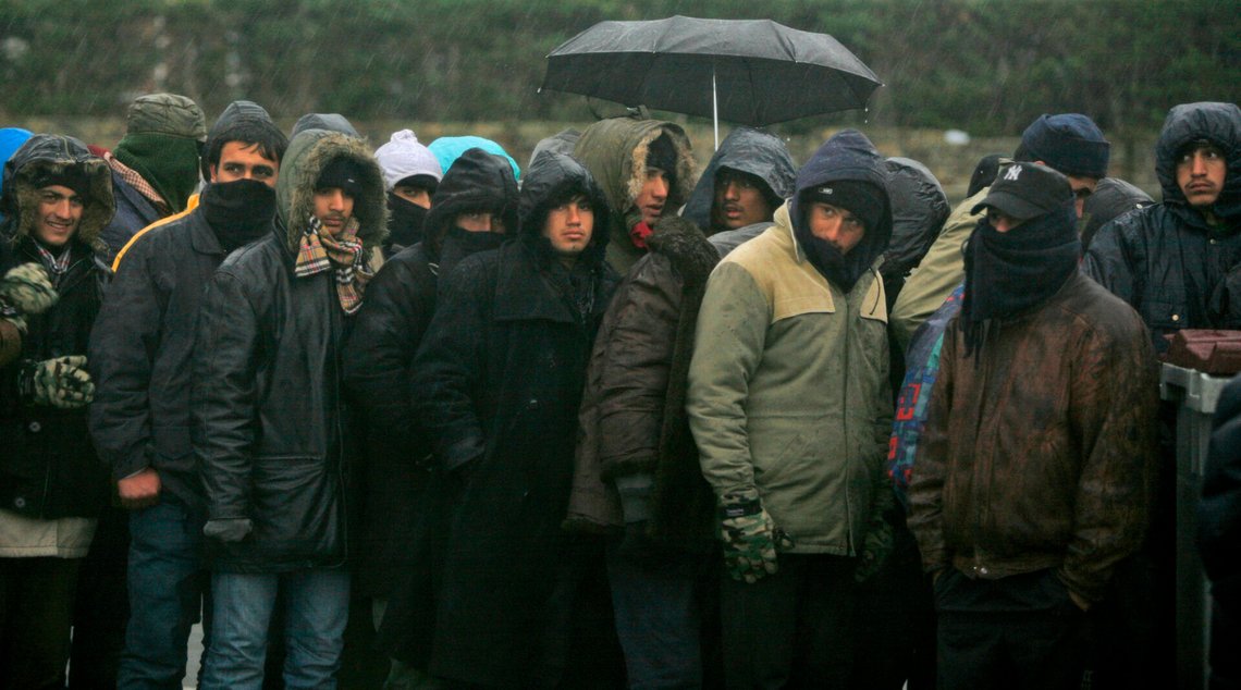 Illegal immigrants line up to receive food provided by a charity organization, at the Calais dockyard, northern France, close to the secured ferry zone where ships depart for England, Sunday, Nov. 23, 2008. The borders of Europe may be expanding but thousands of migrants continue to smuggle themselves across Europe, risking everything in their attempt to reach Britain which they call "the promised land". Hundreds of refugees mostly from Afghanistan, Pakistan and Iran spend up to US$ 10,000 (GBP 6,700; euro 7,700) on harrowing journeys taking several months to this port town of Calais, just 30 kilometers (19 miles) to Britain across the English Channel. (AP Photo/Muhammed Muheisen) Illegal immigrants line up to receive food provided by a charity organization, at the Calais dockyard, northern France, close to the secured ferry zone where ships depart for England, Sunday, Nov. 23, 2008. The borders of Europe may be expanding but thousands of migrants continue to smuggle themselves across Europe, risking everything in their attempt to reach Britain which they call "the promised land". Hundreds of refugees mostly from Afghanistan, Pakistan and Iran spend up to US$ 10,000 (GBP 6,700; euro 7,700) on harrowing journeys taking several months to this port town of Calais, just 30 kilometers (19 miles) to Britain across the English Channel. (AP Photo/Muhammed Muheisen)