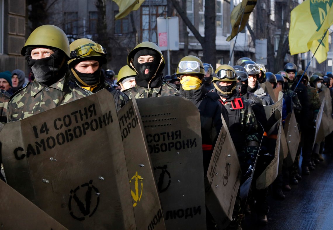 Anti-government protesters armed with sticks and shields rally near the parliament building in central Kiev, Ukraine, Thursday, Feb. 6, 2014. The threat of new protest violence in Ukraine is tapering off with an uneasy truce between police and protesters, but the country's two-month-old political and economic crisis remains far from being resolved, the European Union's foreign policy chief Catherine Ashton said Wednesday. (AP Photo/Darko Bandic) Anti-government protesters armed with sticks and shields rally near the parliament building in central Kiev, Ukraine, Thursday, Feb. 6, 2014. The threat of new protest violence in Ukraine is tapering off with an uneasy truce between police and protesters, but the country's two-month-old political and economic crisis remains far from being resolved, the European Union's foreign policy chief Catherine Ashton said Wednesday. (AP Photo/Darko Bandic)