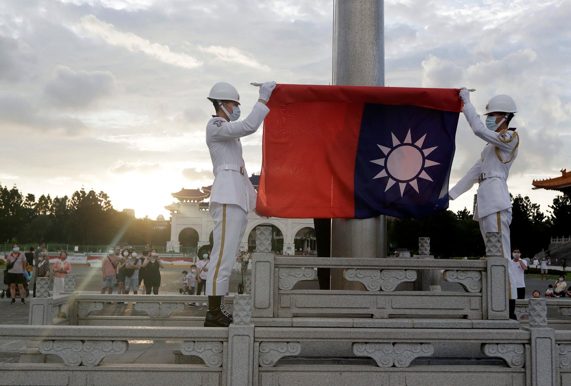 FILE - Two soldiers fold the national flag during the daily flag ceremony in Liberty Square of Chiang Kai-shek Memorial Hall in Taipei, Taiwan, on July 30, 2022. Taiwan said Monday, Jan. 22, 2024 that six Chinese balloons either flew over the island or through airspace just north of it, while Chinese warplanes and navy ships were also detected in the area. (AP Photo/Chiang Ying-ying, File) FILE - Two soldiers fold the national flag during the daily flag ceremony in Liberty Square of Chiang Kai-shek Memorial Hall in Taipei, Taiwan, on July 30, 2022. Taiwan said Monday, Jan. 22, 2024 that six Chinese balloons either flew over the island or through airspace just north of it, while Chinese warplanes and navy ships were also detected in the area. (AP Photo/Chiang Ying-ying, File)