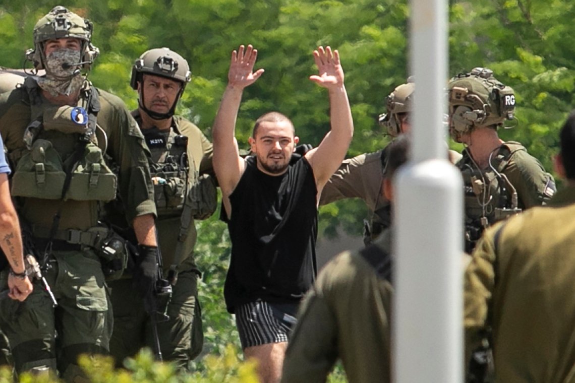 CORRECTS AGE: Almog Meir Jan, 22, kidnapped from Israel in a Hamas-led attack on Oct. 7, 2023, raises his hands after arriving by helicopter to the Sheba Medical Center in Ramat Gan, Israel, Saturday, June 8, 2024. Israel says it has rescued four hostages in Gaza who were kidnapped in a Hamas-led attack on Oct. 7. (AP Photo/Tomer Appelbaum) CORRECTS AGE: Almog Meir Jan, 22, kidnapped from Israel in a Hamas-led attack on Oct. 7, 2023, raises his hands after arriving by helicopter to the Sheba Medical Center in Ramat Gan, Israel, Saturday, June 8, 2024. Israel says it has rescued four hostages in Gaza who were kidnapped in a Hamas-led attack on Oct. 7. (AP Photo/Tomer Appelbaum)