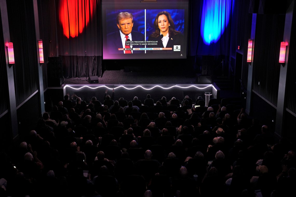 People watch the presidential debate between Republican presidential nominee former President Donald Trump and Democratic presidential nominee Vice President Kamala Harris at the Aztec theater Tuesday, Sept. 10, 2024, in Shawnee, Kan. (AP Photo/Charlie Riedel) People watch the presidential debate between Republican presidential nominee former President Donald Trump and Democratic presidential nominee Vice President Kamala Harris at the Aztec theater Tuesday, Sept. 10, 2024, in Shawnee, Kan. (AP Photo/Charlie Riedel)