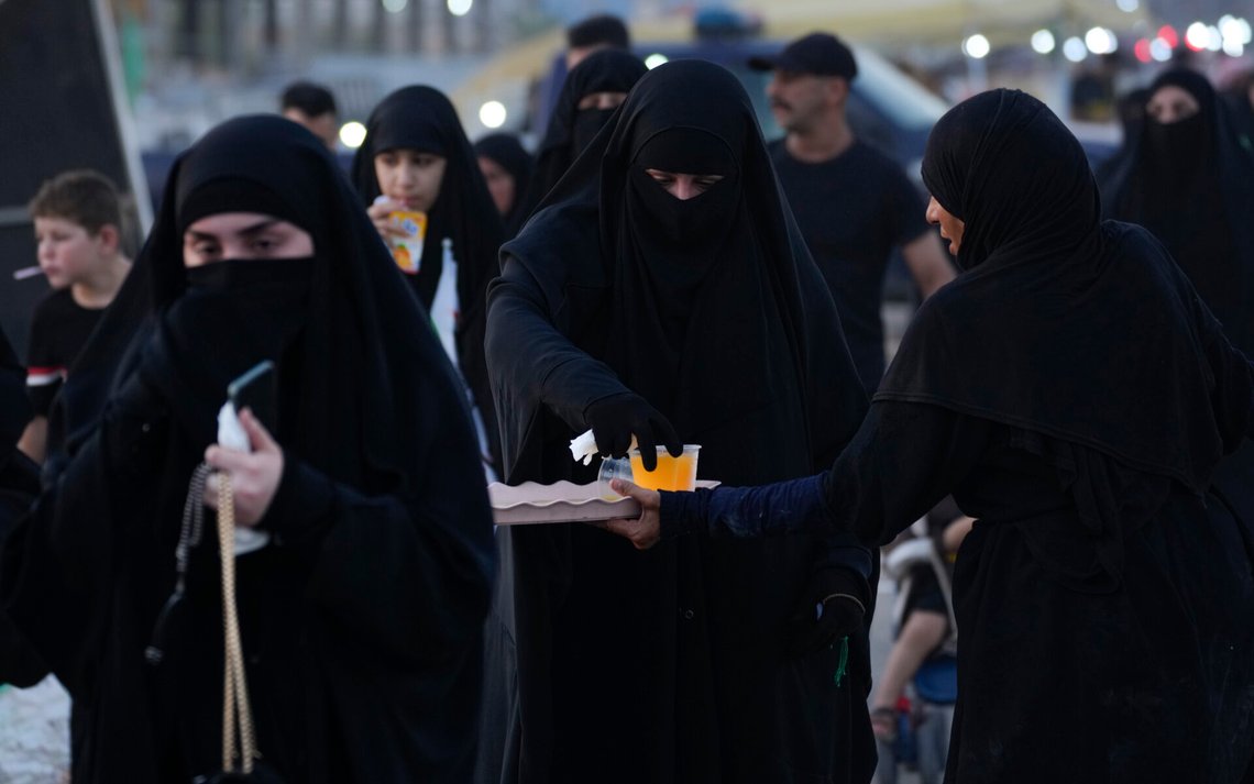Shiite pilgrims march to Karbala for the Arbaeen ritual, the holiday that marks the end of the forty day mourning period after the anniversary of the martyrdom of Imam Hussein, the Prophet Muhammad's grandson in the 7th century, in Baghdad, Iraq, Thursday, Aug. 22, 2024. (AP Photo/Hadi Mizban) Shiite pilgrims march to Karbala for the Arbaeen ritual, the holiday that marks the end of the forty day mourning period after the anniversary of the martyrdom of Imam Hussein, the Prophet Muhammad's grandson in the 7th century, in Baghdad, Iraq, Thursday, Aug. 22, 2024. (AP Photo/Hadi Mizban)