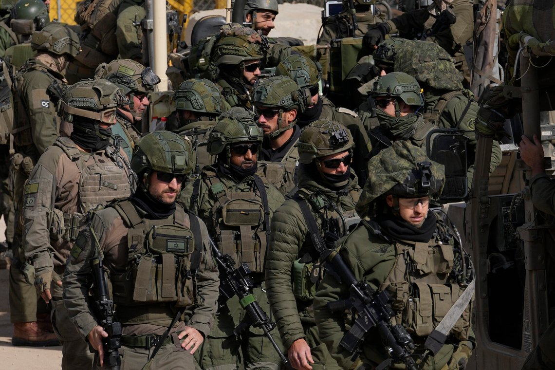 Israeli soldiers stand next to armoured vehicles before crossing the security fence, moving towards the so-called Alpha Line that separates the Israeli-controlled Golan Heights from Syria, in the town of Majdal Shams, Thursday, Dec. 12, 2024. (AP Photo/Matias Delacroix) Israeli soldiers stand next to armoured vehicles before crossing the security fence, moving towards the so-called Alpha Line that separates the Israeli-controlled Golan Heights from Syria, in the town of Majdal Shams, Thursday, Dec. 12, 2024. (AP Photo/Matias Delacroix)